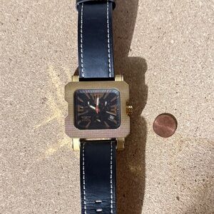 In it a Large Gold and Black Square Watch